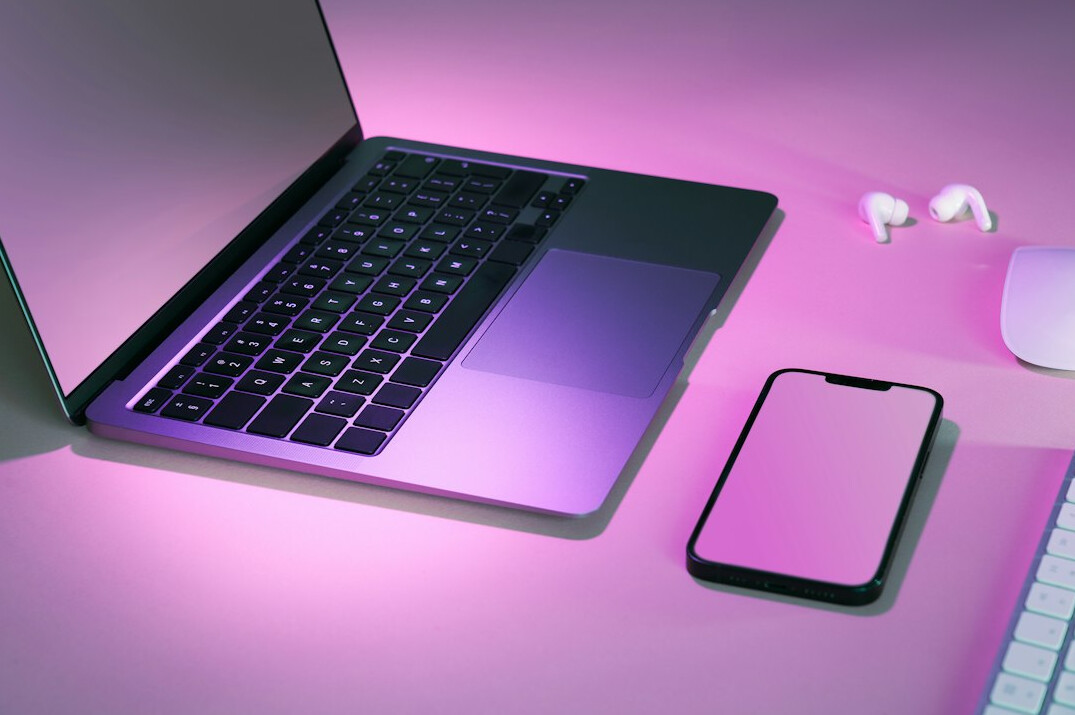 Laptop workspace with video editing software and headphones
